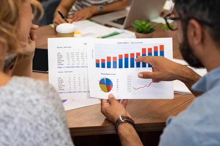 Photo of people looking at a graph