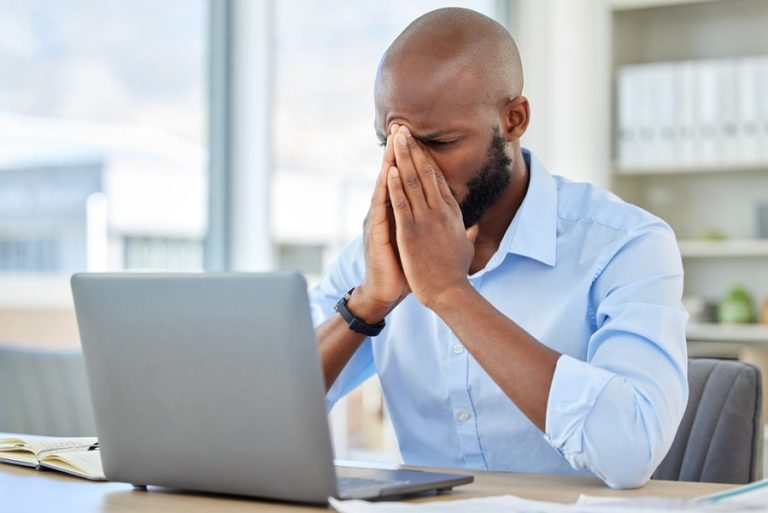 photo of a tired man with a laptop