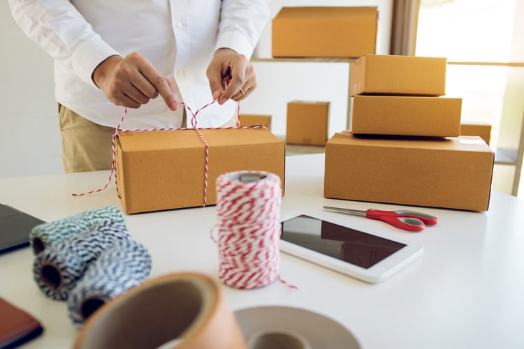 photo of a person wrapping product boxes